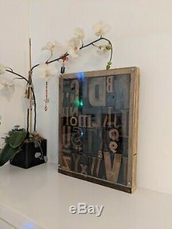 Vintage letterpress wood type printing blocks alphabet letters in display case