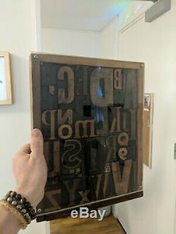 Vintage letterpress wood type printing blocks alphabet letters in display case